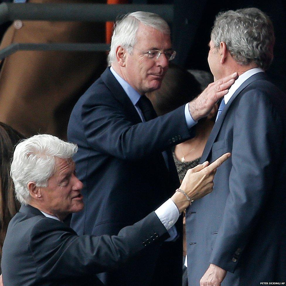 Former British Prime Minister John Major (centre) greets former US Presidents George W Bush (right) and Bill Clinton (left)