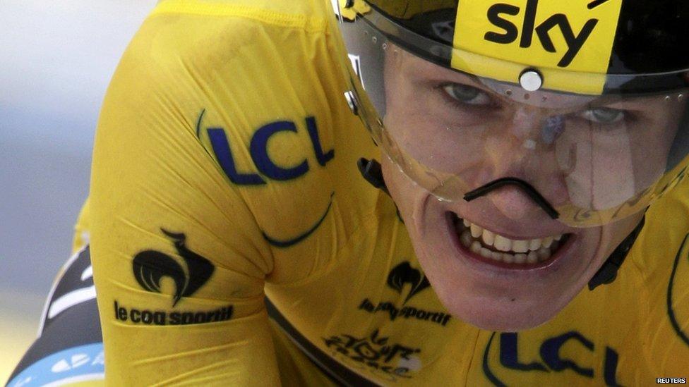 Chris Froome grits teeth while cycling in yellow jersey