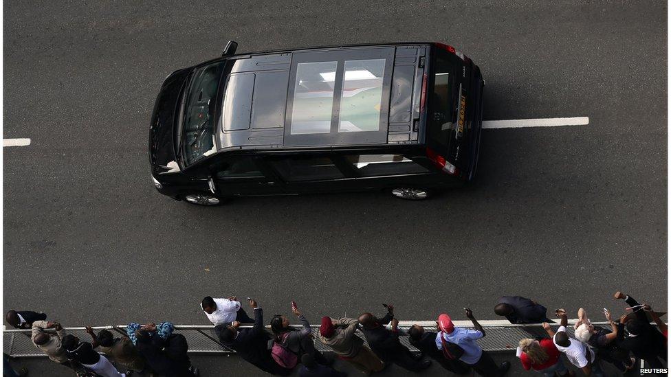 The hearse carrying the coffin of former South African President Nelson Mandela travels through a street of Pretoria December 11