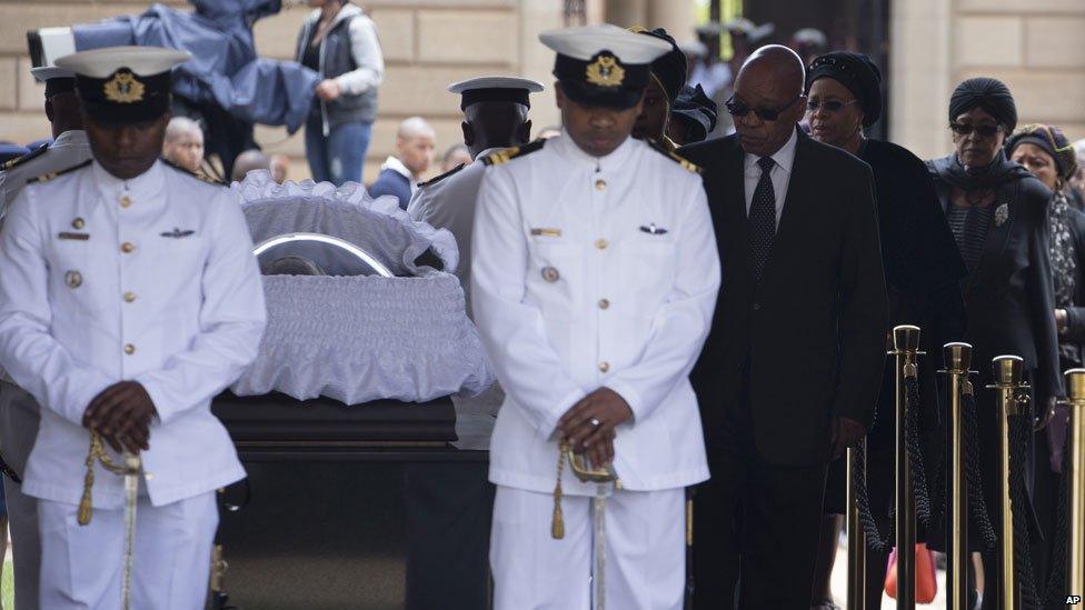 Jacob Zuma, Graca Machel and Winnie Mandela approach Nelson Mandela's coffin