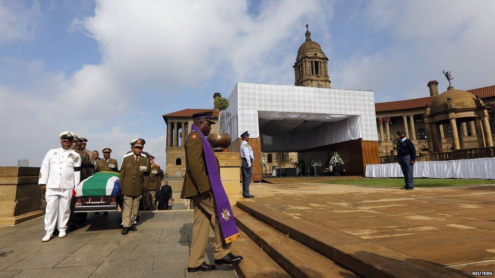 Military personnel carry the remains of the late Nelson Mandela at the Union Buildings in Pretoria, 11 December