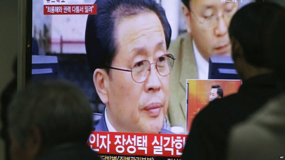 People watch a TV news programme showing North Korean leader Kim Jong-un's uncle, Chang Song-thaek, at the Seoul Railway Station in Seoul, South Korea, on 3 December 2013