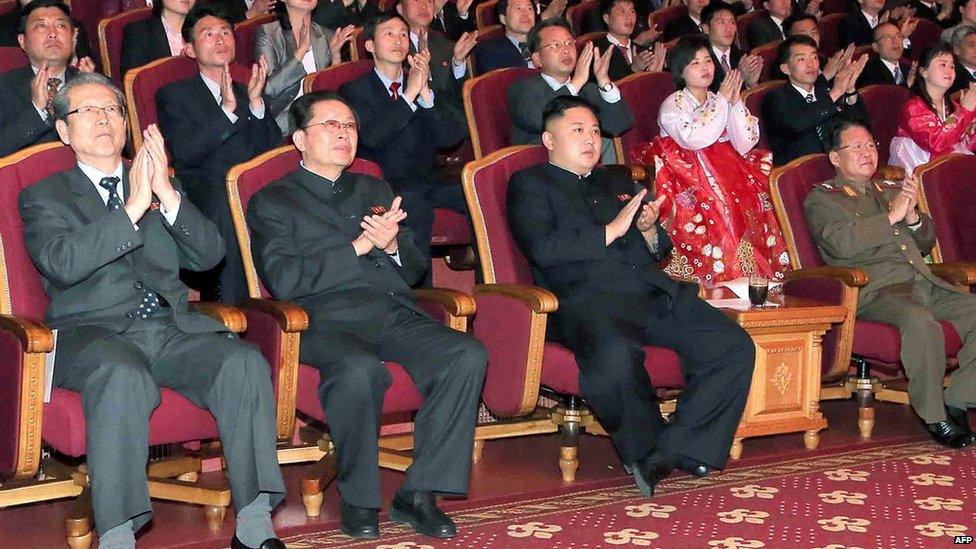 KCNA image released on 15 April 2013 shows Kim Jong-un (C-front) applauding at the Unhasu orchestra concert at the People's Theatre in Pyongyang to celebrate the 101st anniversary of the birth of late leader Kim Il-sung, as his uncle, Chang Song-thaek (front 2nd L), looks on