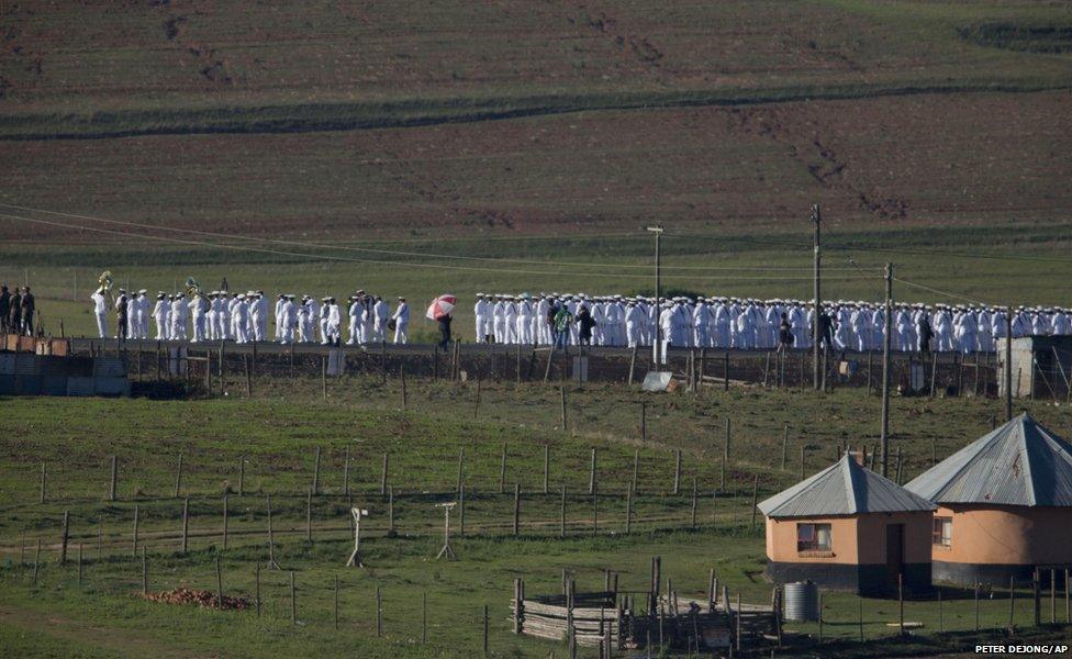 Members of the South African Navy line the road from the Mandela family house to his burial site in Qunu