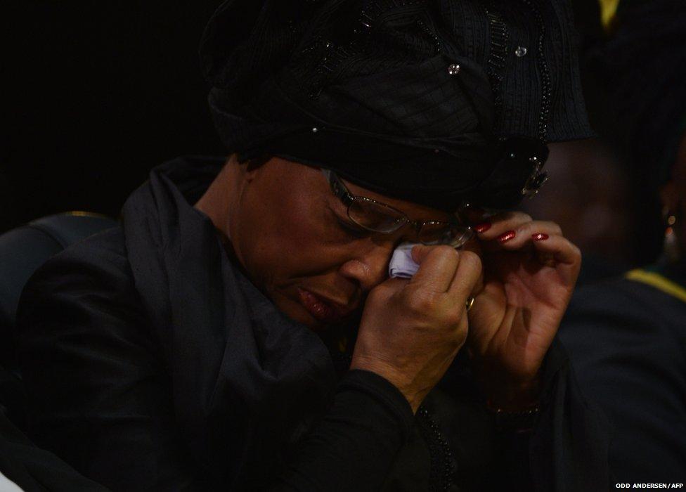 The widow of Nelson Mandela Graca Machel wipes her tears