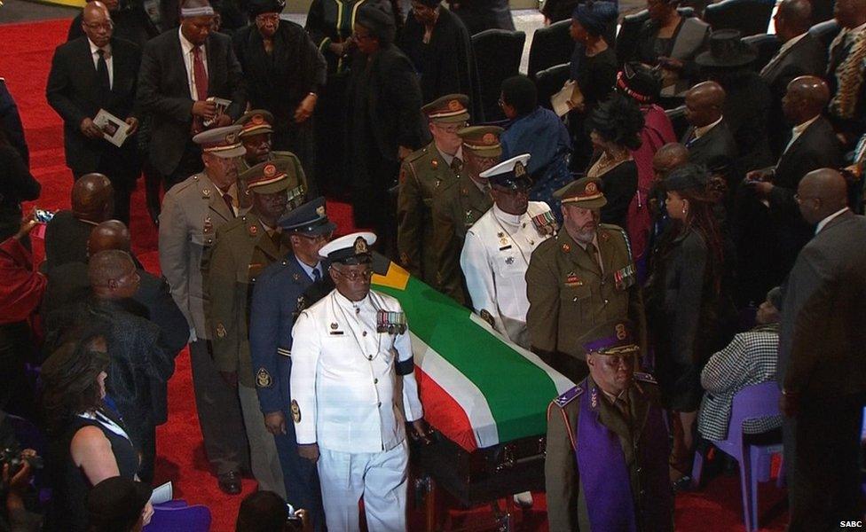 The coffin of former South African President Nelson Mandela is carried by military personnel