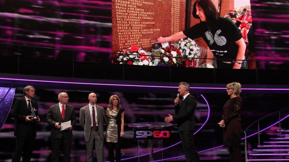 Alan Hansen presents the Helen Rollason Award 2013 to Danny Gordon (brother), Michael Williams (son) and Sara Williams (daughter) of winner Anne Williams during the 2013 BBC Sports Personality of the Year Awards at the First Direct Arena, Leeds.