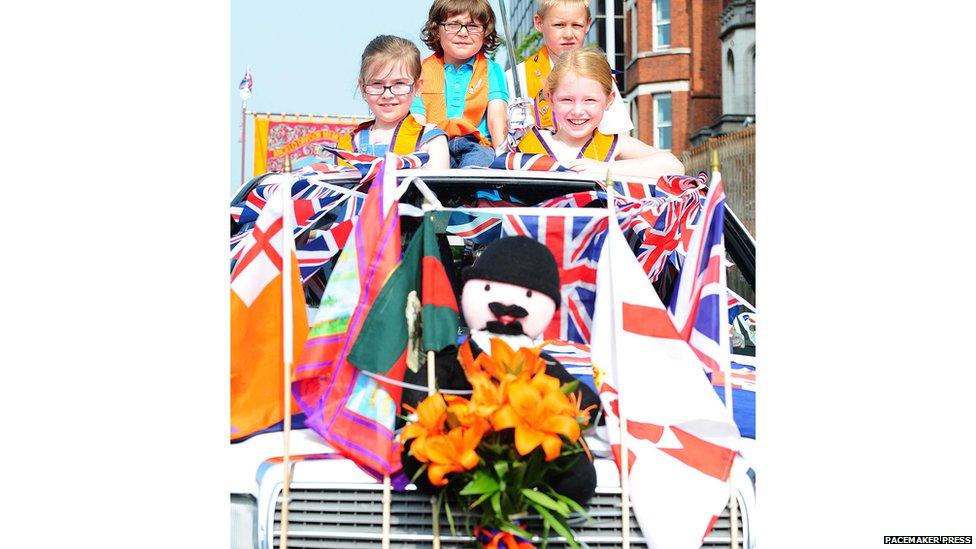 Orangeman on front of car