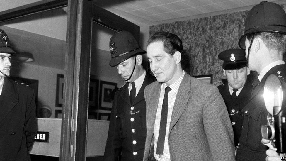 Biggs, leaving Aylesbury Courts of Assize in April 1964, after being sentenced to 30 years in prison