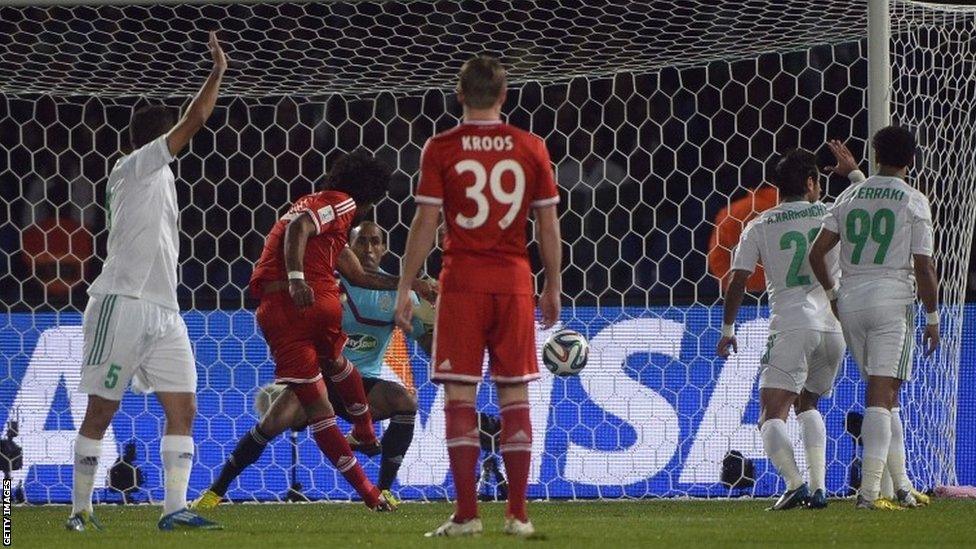 Bayern Munich's Brazilian defender Dante shoots the ball past Raja's Moroccan goalkeeper Khalid Askri during the Fifa Club World Cup final match in the Moroccan city of Marrakech