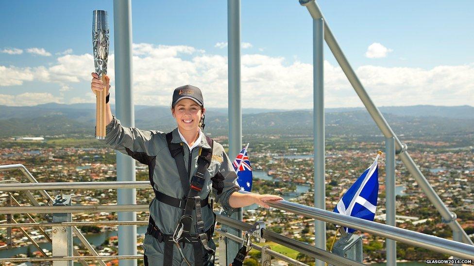 Australian Commonwealth diver Brittany Broben poses with the Queen's Baton at the top of Q1 tower as the relay arrived in Gold Coast, Australia.