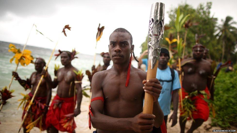 The Queen's baton is carried to a traditional ceremony in Kavieng, Papua New Guinea.