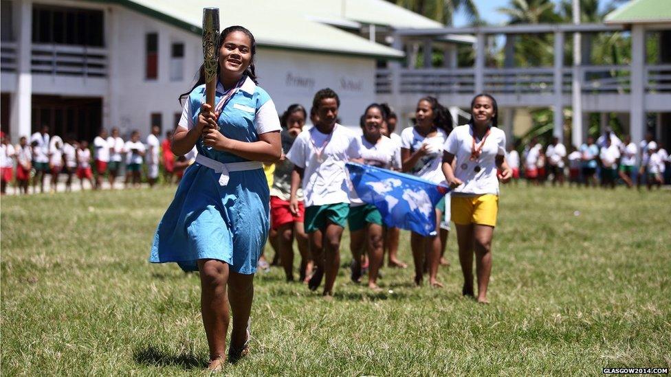 A local school girl runs with the Queen's Baton at Nauti Primary School in Funafuti, Tuvalu.