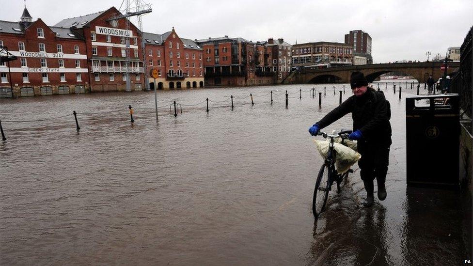 Rising water levels from the River Ouse bring floodwater into riverside roads in York City centre as heavy rain and gales sweep across many parts of the UK.