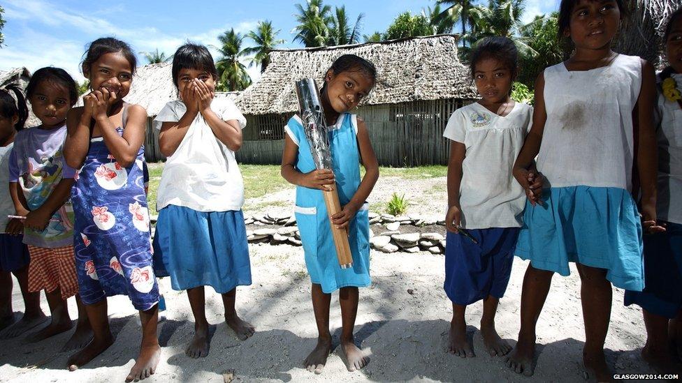 Students from Uekera Primary School pose with the Queen's Baton in Tarawa, Kiribati.