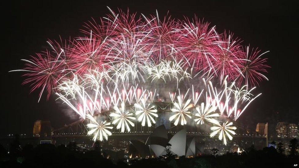 Fireworks explode over the Harbour Bridge and the Opera House during New Year's Eve celebrations in Sydney