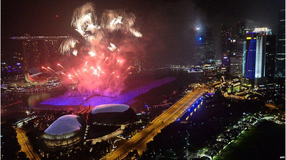 Fireworks burst over the Singapore skyline during New Year celebrations on January 1, 2014