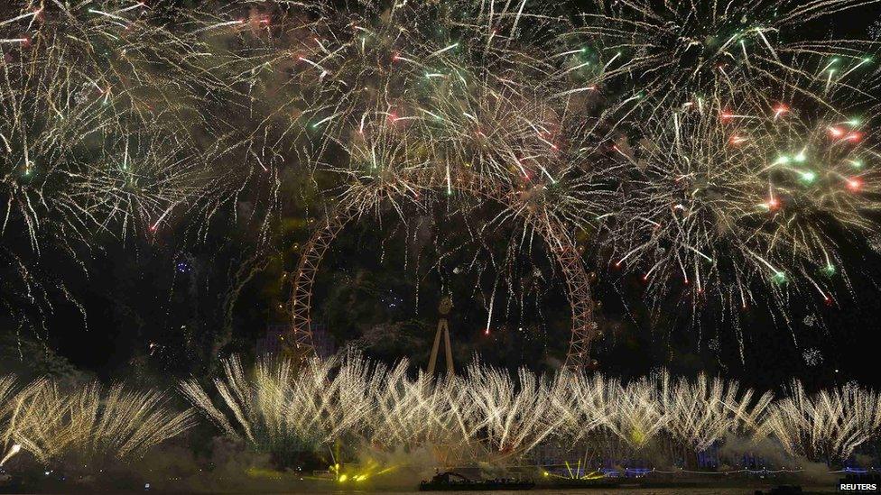 Fireworks explode around the London Eye wheel during New Year celebrations