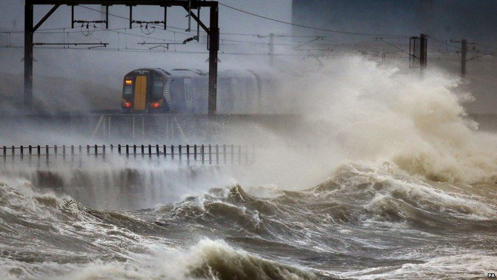 A train passes through the coast at Saltcoats in Scotland