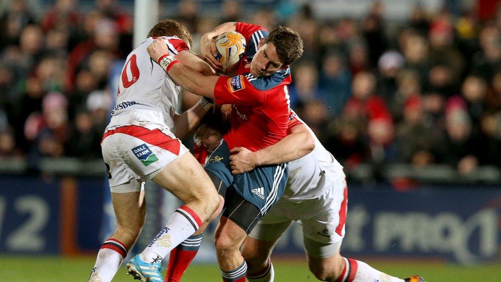 Ulster's Paddy Jackson and Tom Court combine to tackle Munster fly-half Ian Keatley