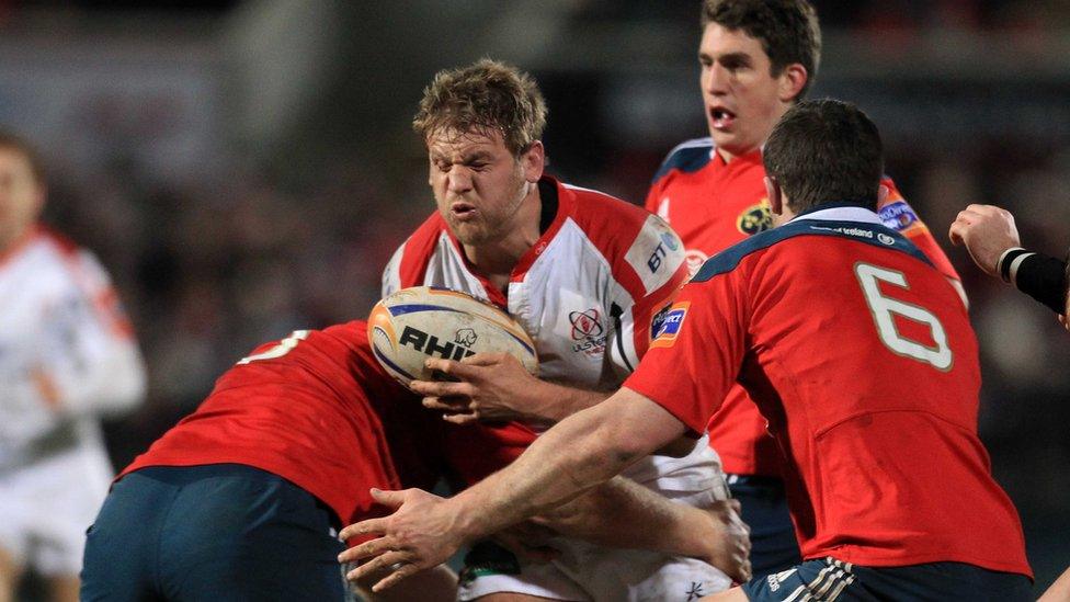 Ulster flanker Chris Henry is tackled by Munster duo Stephen Archer and Peter O'Mahony