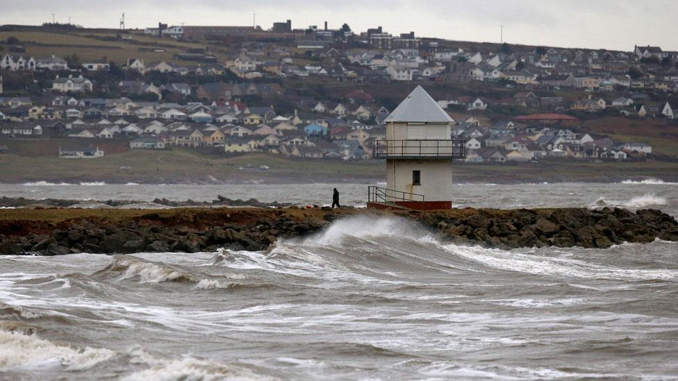 A man walks along the jetty at Porthcawl