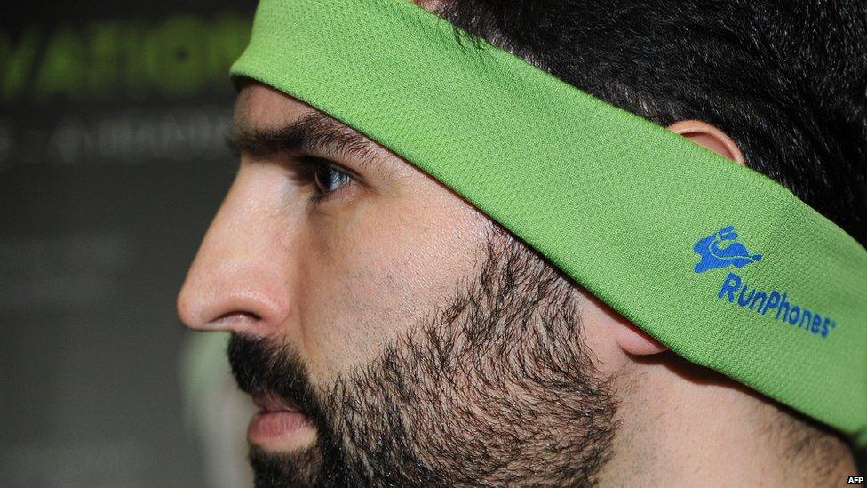 Casey Macioge shows off the RunPhones headband which comes with removable headphones designed to stay put during a work out. The moisture absorbing material is thin enough to allow runners to hear surrounding traffic.