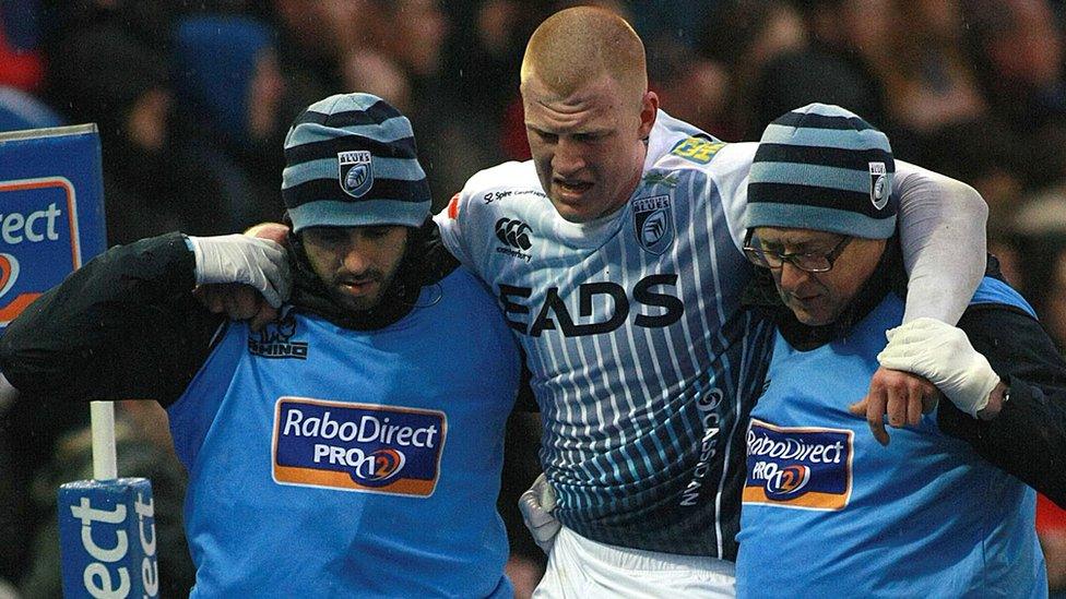 Rhys Patchell is helped off the field by Cardiff Blues medical staff