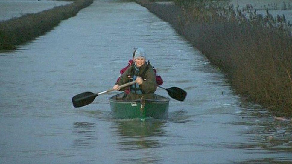 David and Tracey Bradley in their canoe on a flooded Somerset Levels. Still from BBC News Channel