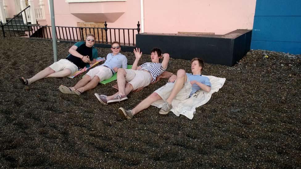 Students on shingle at Aberystwyth promenade