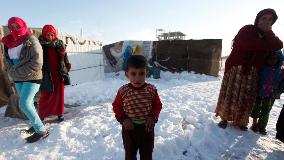 A child refugee from the northern province of Raqqa in Syria, reacts from the cold weather in a Syrian refugee camp beside the Lebanese border town of Arsal, in eastern Bekaa Valley (December 12)