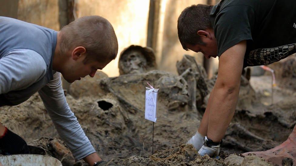 Diggers at a mass grave