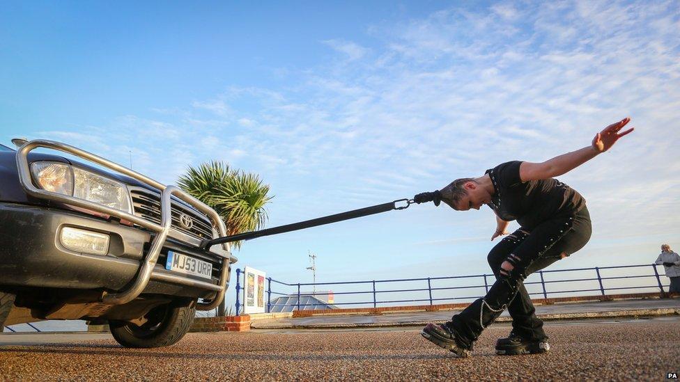 Circus performer pulls car with her hair