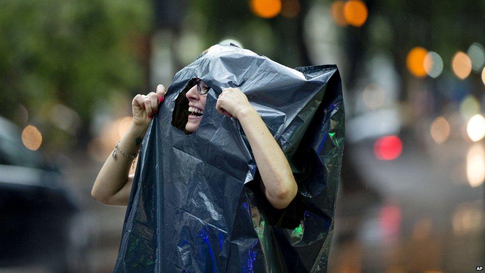 A woman wearing plastic rubbish bag