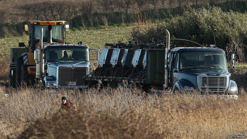 Equipment arrives on transport as military personnel and emergency services attend the scene at Cley next the Sea of USAF helicopter crash