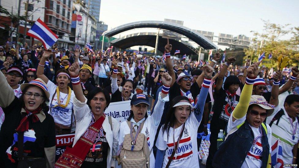 Anti-government protesters block the road at a major intersections in Bangkok on 13 January 2014