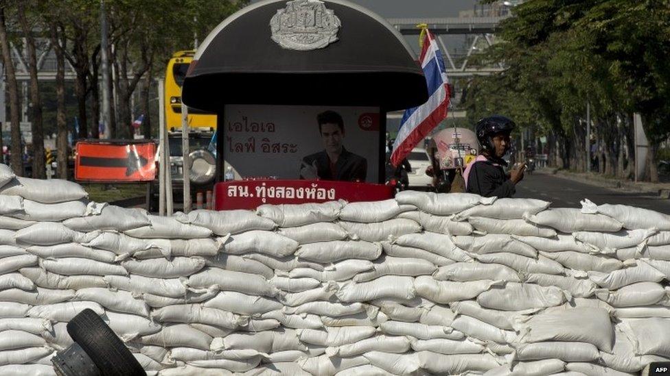 Anti-government protesters block an intersection during a rally in Bangkok on 13 January 2014