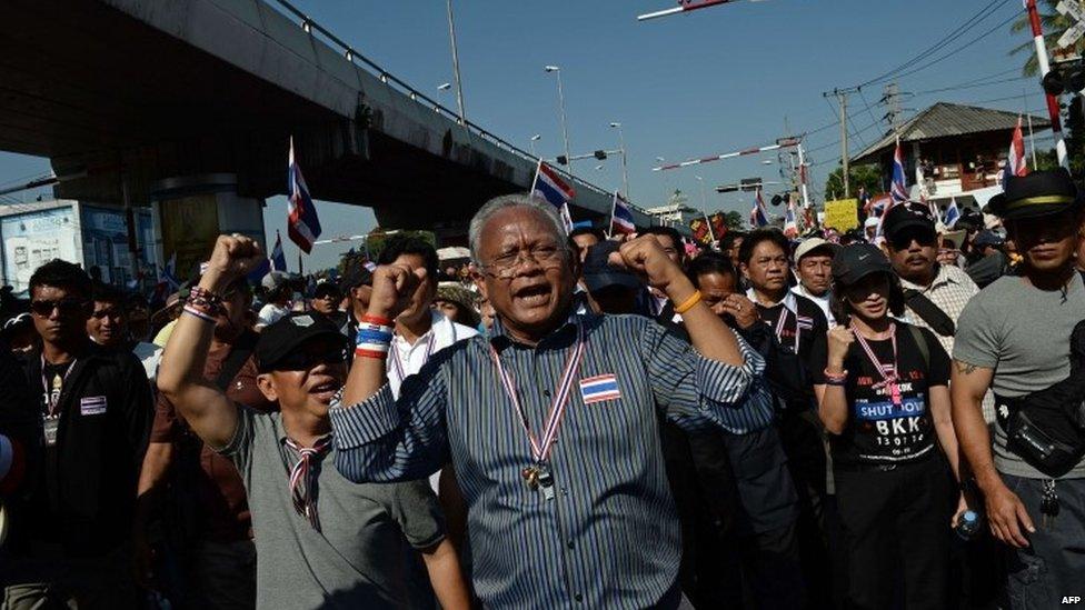 Thai protest leader Suthep Thaugsuban (C) sings a song along with anti-government protesters as they march through the streets of Bangkok in a move to "shut down" the city on 13 January 2014