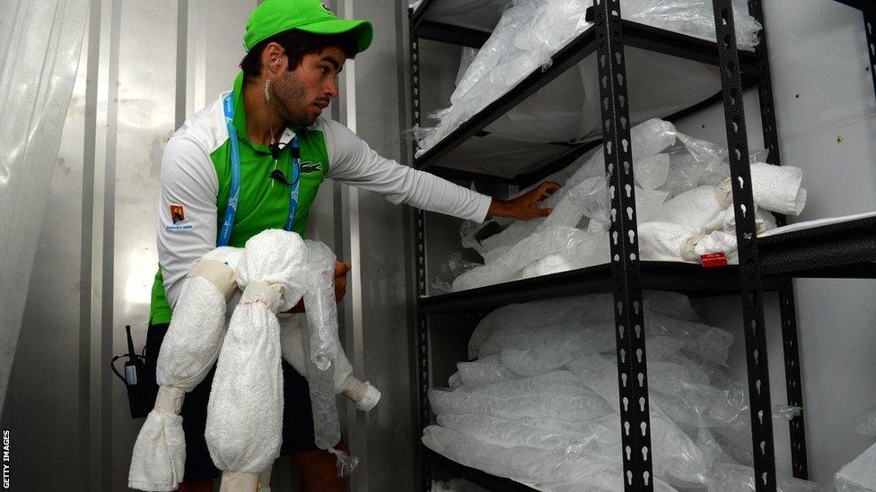 James O'Grady of court services and operations prepares ice vests and ice filled collars for players