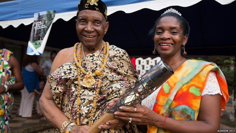 Ezekiel Cofie holds the Queen's Baton with his daughter Zetta Cofie, in Accra, Ghana.