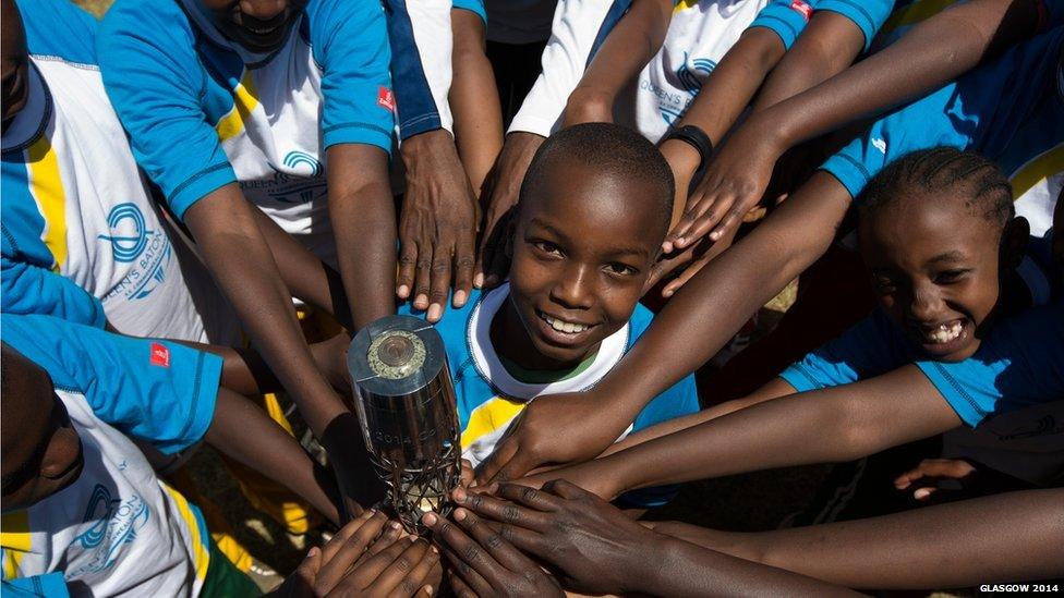 School children hold the Queen's baton in Karura Forest in Nairobi, Kenya.