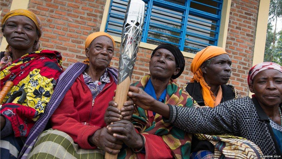 Community elders in Musanze, Rwanda hold the Queen's baton during the tour of the country.