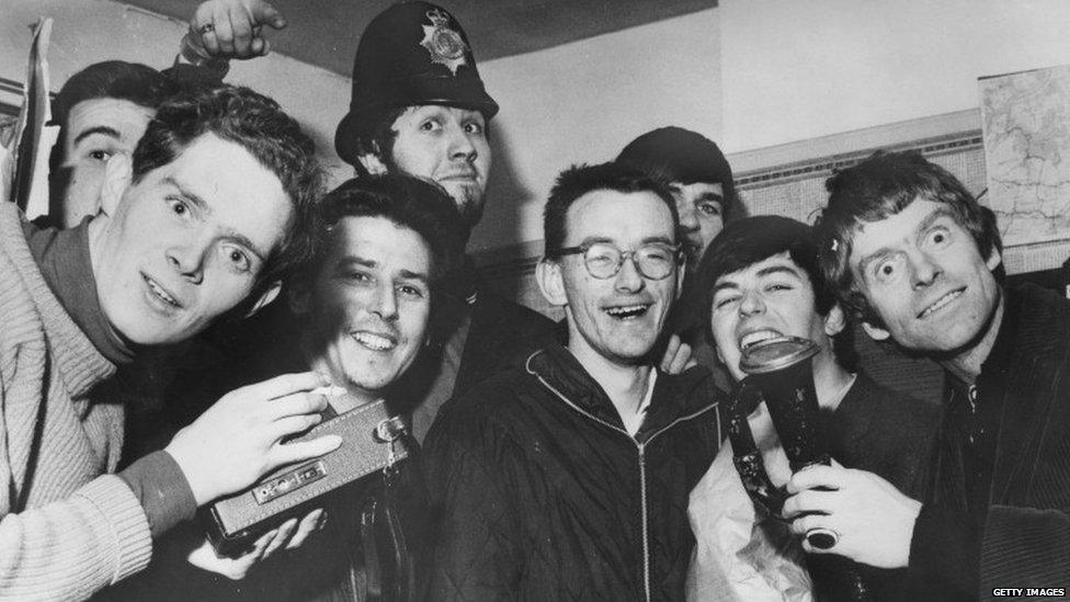 Radio Caroline DJs including Dave Lee Travis and Tony Blackburn at an Essex police station after their ship ran aground in 1966