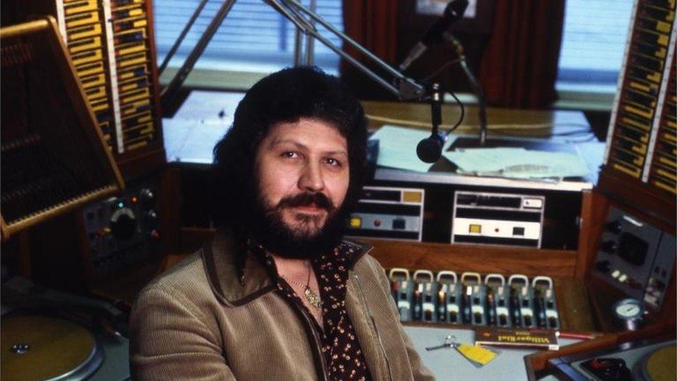 Dave Lee Travis in a radio studio