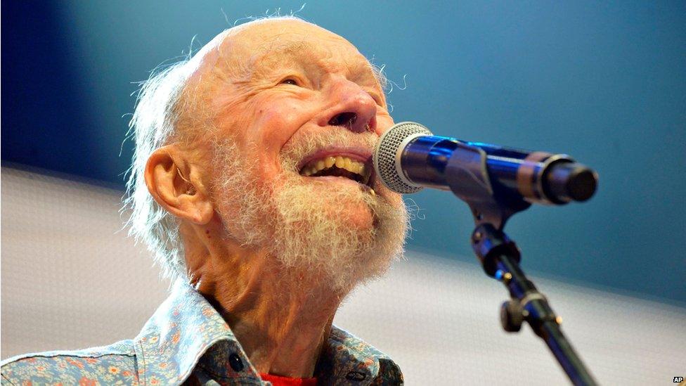 Pete Seeger performing on stage during a Farm Aid concert in September 2013