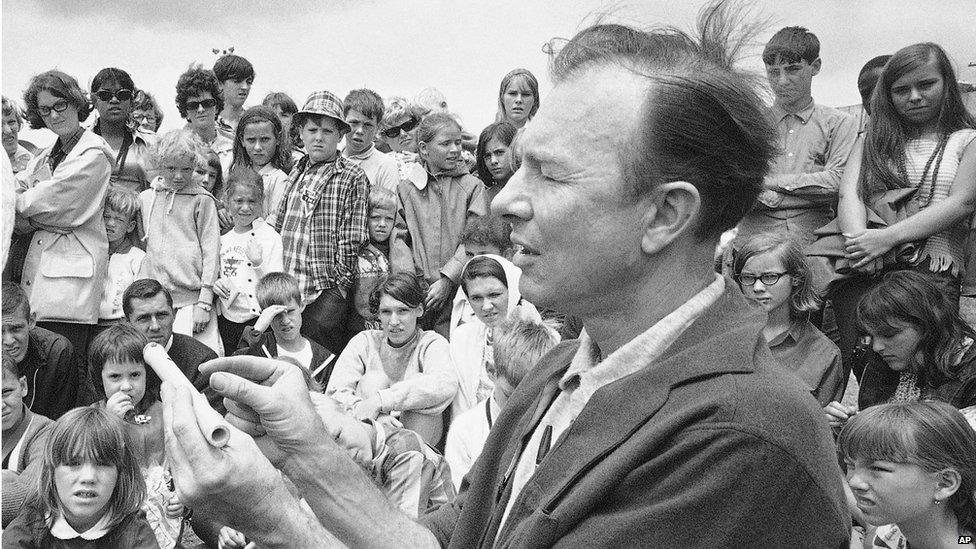 Pete Seeger conducts an instrument making session on Children's Day at the Newport Folk Festival, Rhode Island in July 1966