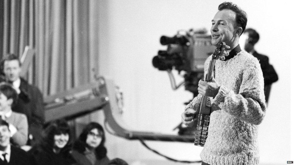 Playing the long-necked, five string banjo that was his trademark instrument, Seeger is shown during the recording of a show for the BBC in 1964