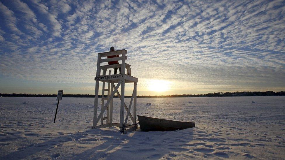 Lifeguard stand is surrounded by snow at a beach in Lake Calhoun, Minneapolis.