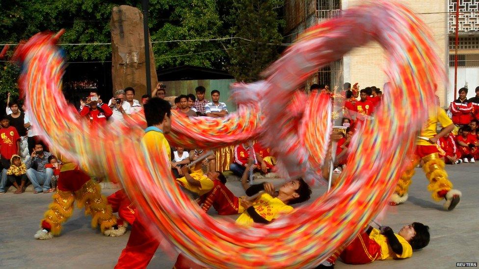 Chinese Cambodian men perform a dragon dance to celebrate the upcoming Chinese new year at the Chinese Embassy in Phnom Penh in Cambodia