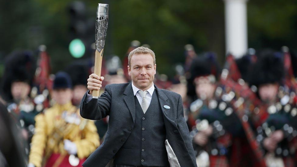 Cyclist Chris Hoy carrying Commonwealth Games baton